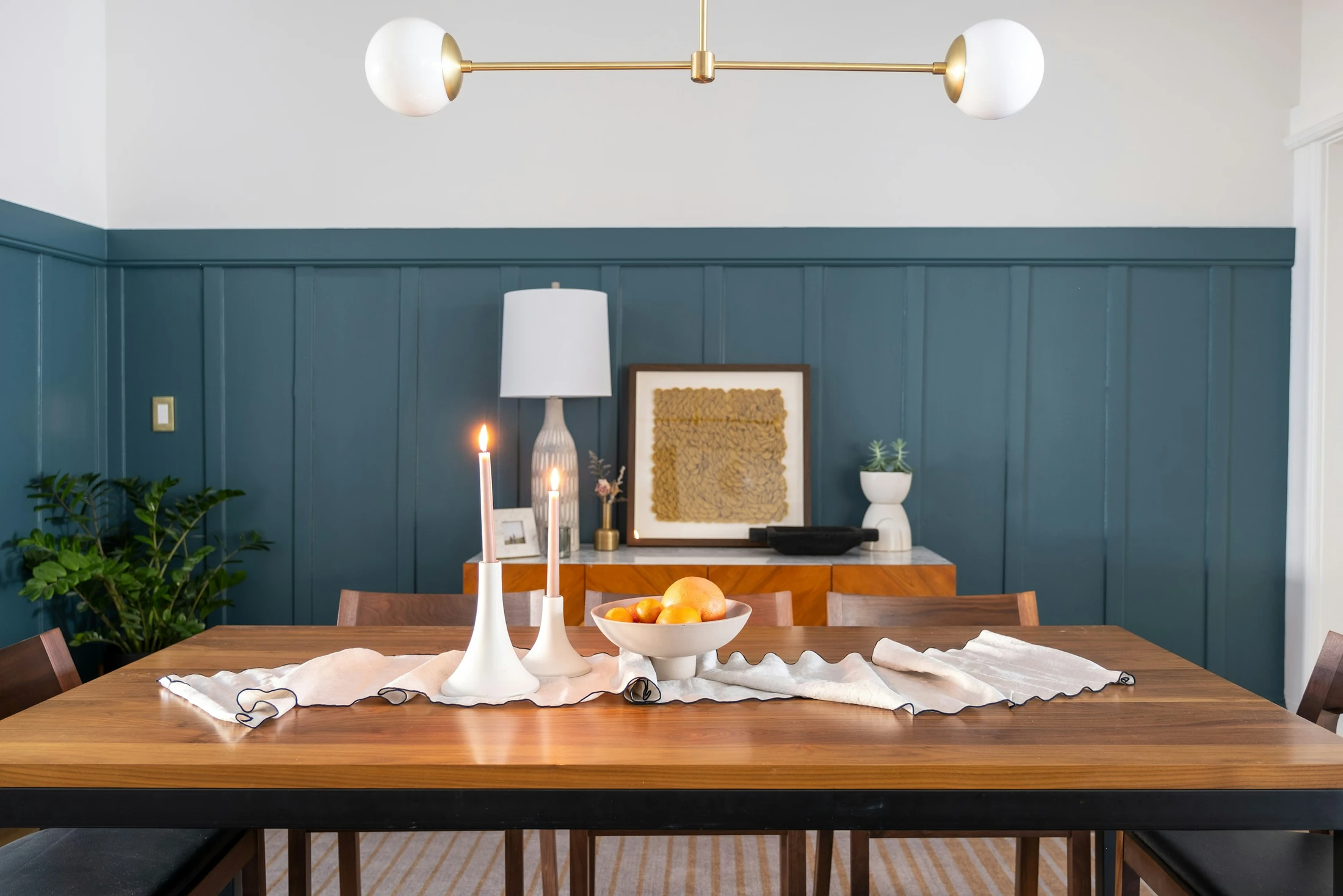 A candlelit walnut dining table